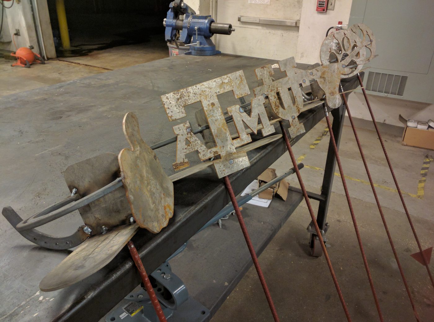 Cut metal team letters in the shop