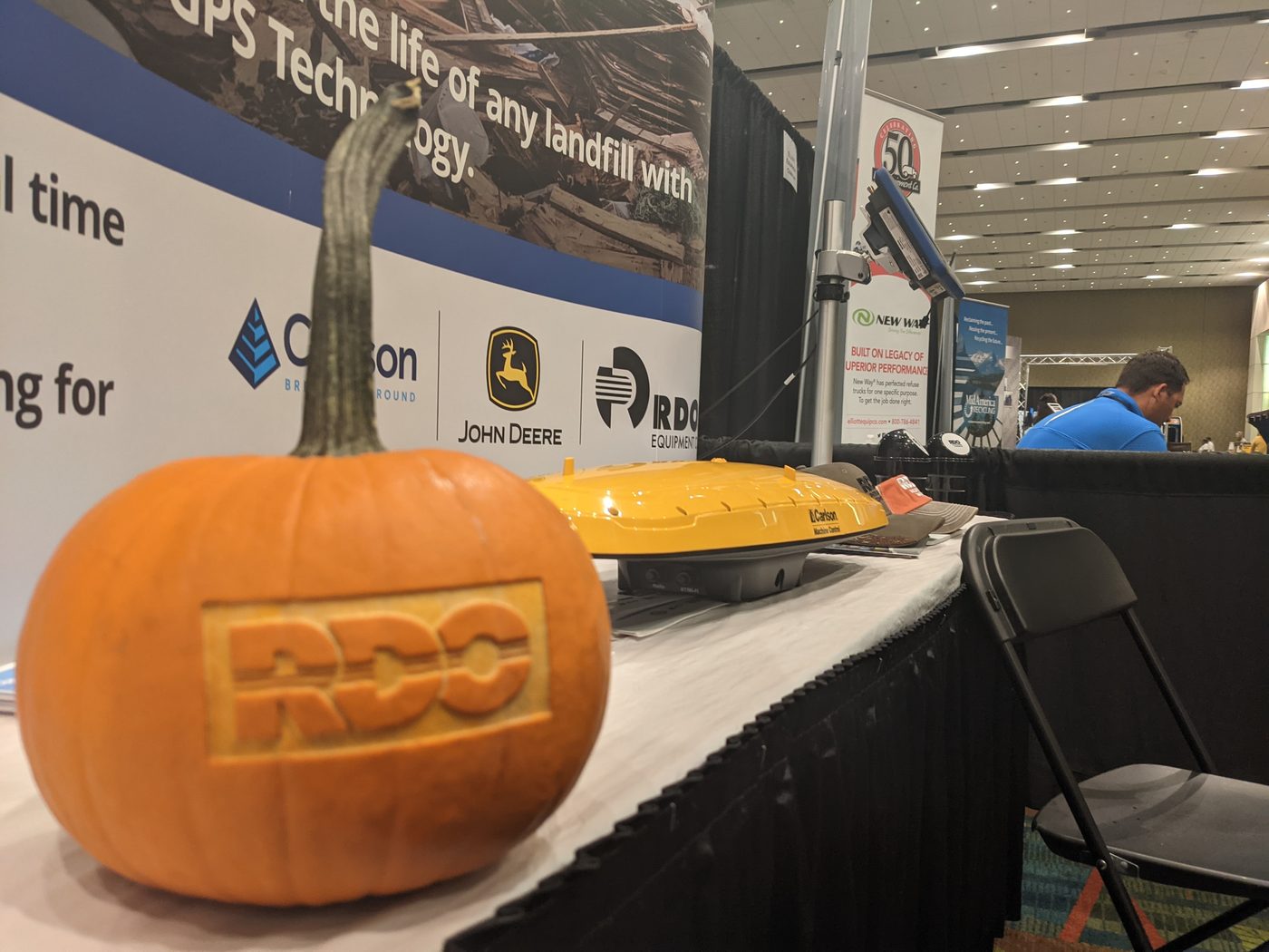 Carved pumpkin with a company logo at a trade show booth