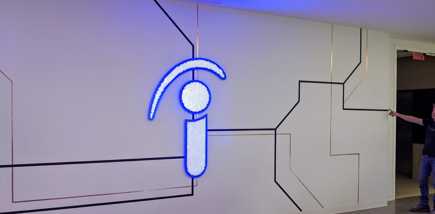 Illuminated logo on the finished wall installation